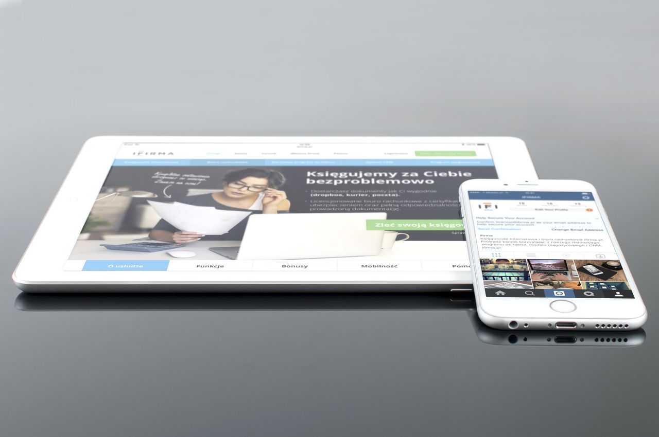 gallery-05 A contemporary tablet and smartphone showing web content on a glossy surface, emphasizing technology and connectivity.